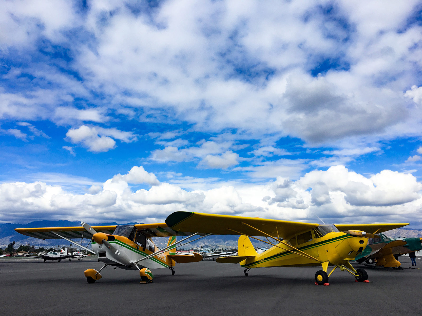 Photo of two yellow airplanes